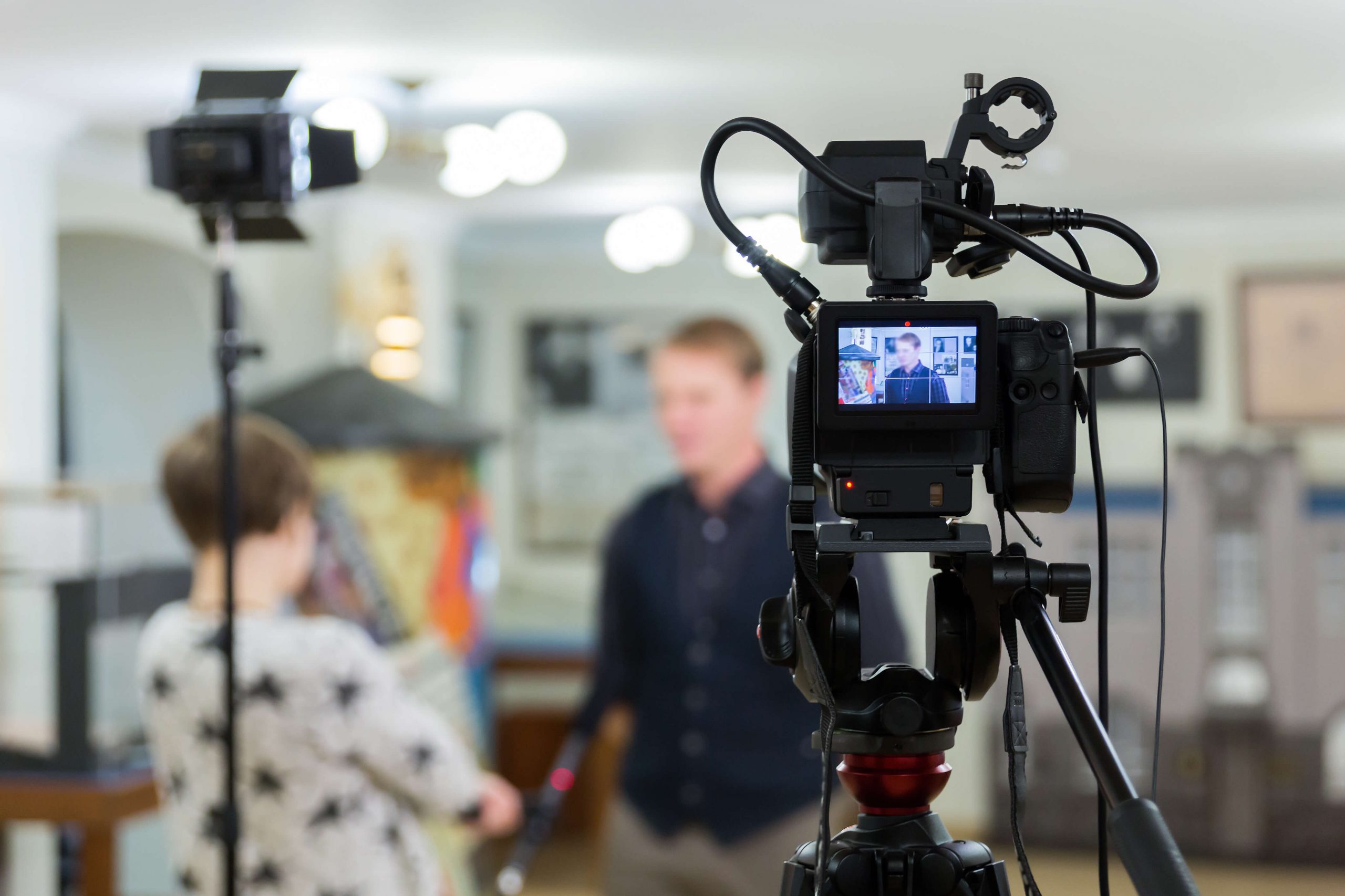 Live stream of an interview with two people in well lit room with cameras pointed at them. 